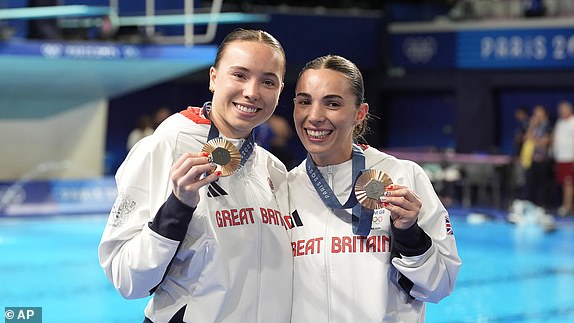 Britain's Yasmin Harper and Scarlett Mew Jensen celebrate their bronze medal win at the women's synchronised 3m springboard diving final at the 2024 Summer Olympics on July 27, 2024. (AP Photo/Lee Jin-man)