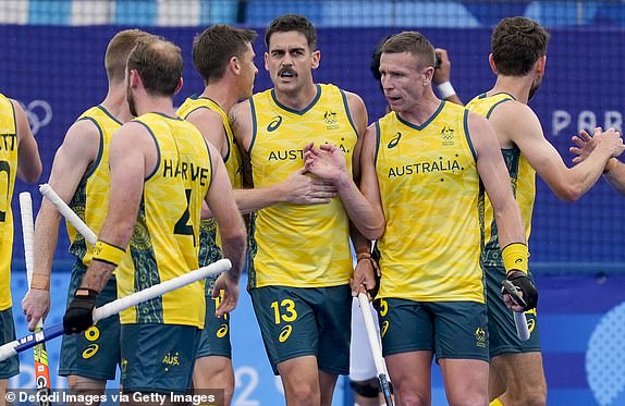 Blake Govers of Australia celebrates after scoring his team's first goal with teammates during the Men's Hockey - Pool B match between Australia and Argentina on Day 1 of the Olympic Games Paris 2024 at Yves-du-Manoir Stadium on July 27, 2024 in Colombes, France. (Photo by Alex Gottschalk/DeFodi Images via Getty Images)