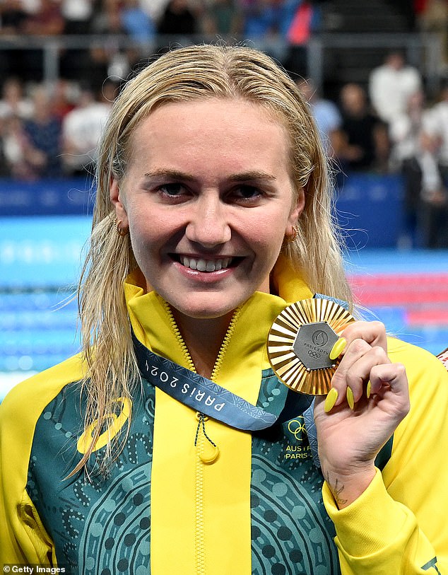 Titmus proudly displaying her second consecutive gold medal in the women's 400m freestyle after her remarkable win