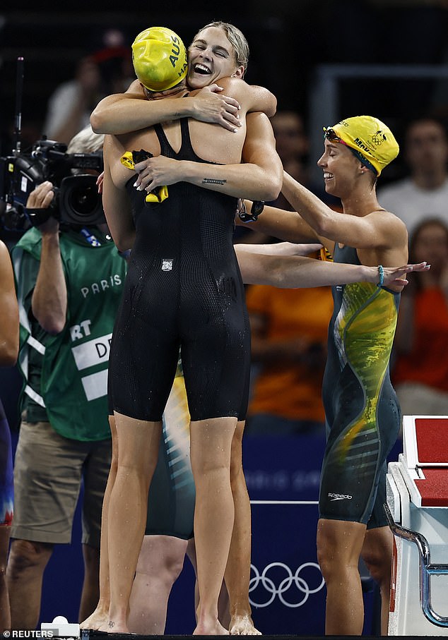 Australia's Shayna Jack (face to camera) hugs Meg Harris as Emma McKeon (right) joins in the celebrations after their win clinched the country's fourth straight Olympic title in the women's 4x100m freestyle relay