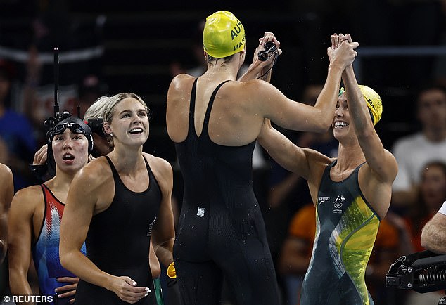 The women set an Olympic record as they led the race from start to finish early on Sunday morning, Australian time (pictured from second left: Shayna Jack, Meg Harris and Emma McKeon celebrate their victory)