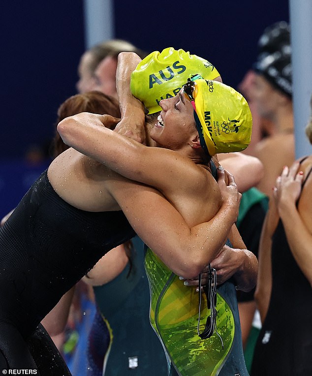 O'Callaghan (left) and Meg Harris embrace after the Aussies once again reigned supreme in the pool - and put the nation into the lead in the medal tally