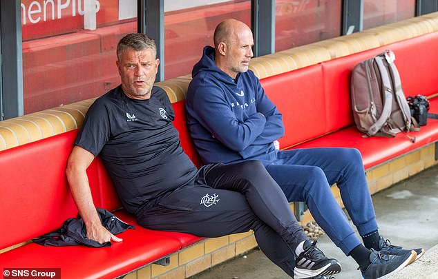 Clement and new assistant boss Andries Ulderink take in the action in Berlin yesterday