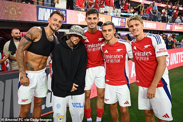 Bieber was one of a number of stars that were in the stands for the match, and was seen taking photos with (L-R) Ben White, Kai Havertz, Leandro Trossard and Odegaard