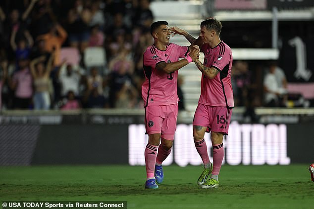 Luis Suarez celebrating with midfielder Robert Taylor after scoring against Puebla