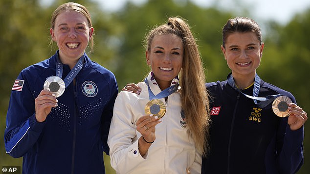 Pauline Ferrand Prevot of France, the winner of the women's mountain biking event, displays her gold medal alongside silver medallist Haley Batten from the US and bronze medallist Jenny Rissveds from Sweden