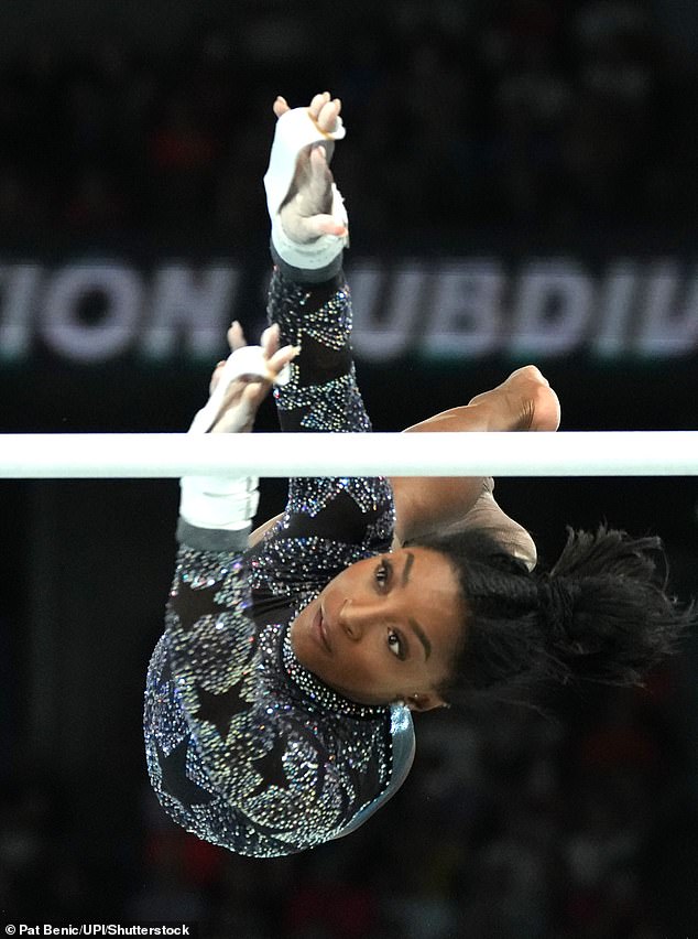 Biles reaches during her routine on the Uneven Bars during Sunday's qualifying round