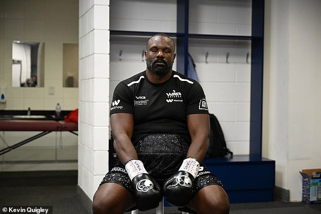 Chisora ponders quietly after having his hands wrapped and gloves put on