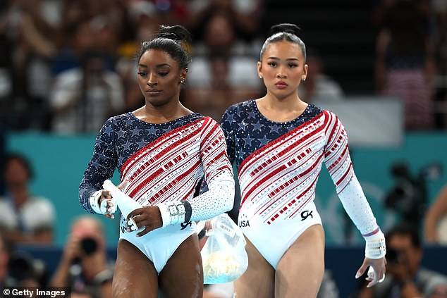 Simone Biles and Sunisa Lee of Team United States look on during Tuesday's action in Paris