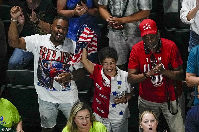 Owens cheered on his wife next to Biles' parents, Nellie and Ron