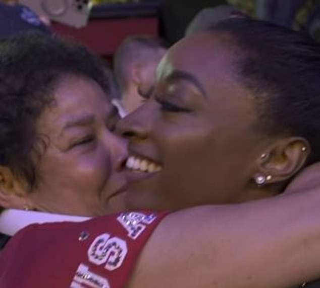 Simone Biles hugs her adoptive mother, Nellie Biles, after winning the team gold for the USA