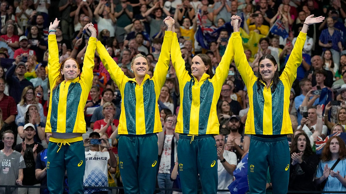 Australian swimmers celebrating on the podium