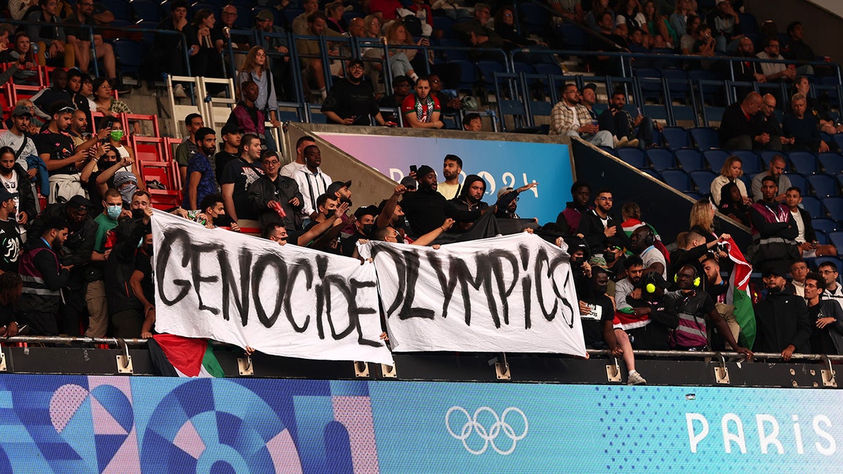 Anti-Israel protesters hold sign reading 'Genocide Olympics'