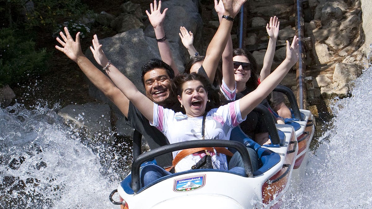 Mario Lopez and family enjoying the Matterhorn Bobsleds.