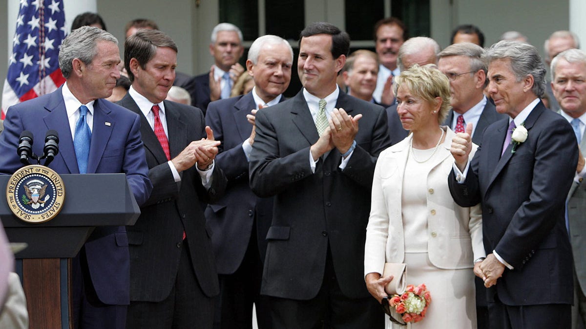 President George W. Bush giving a thumbs up to John Walsh