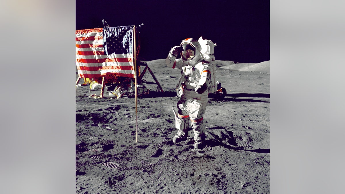 Astronaut Eugene Cernan salutes lunar flag