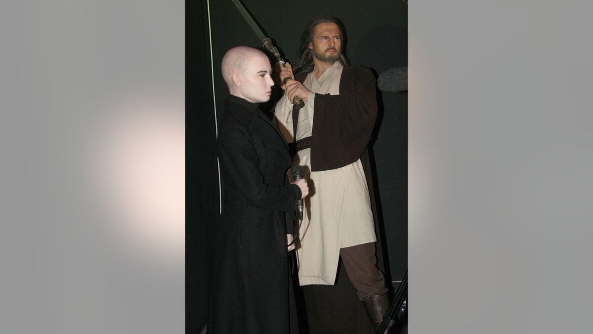 Sinead O'Connor wax figure next to Liam Neeson Qui-Gon Jinn wax figure