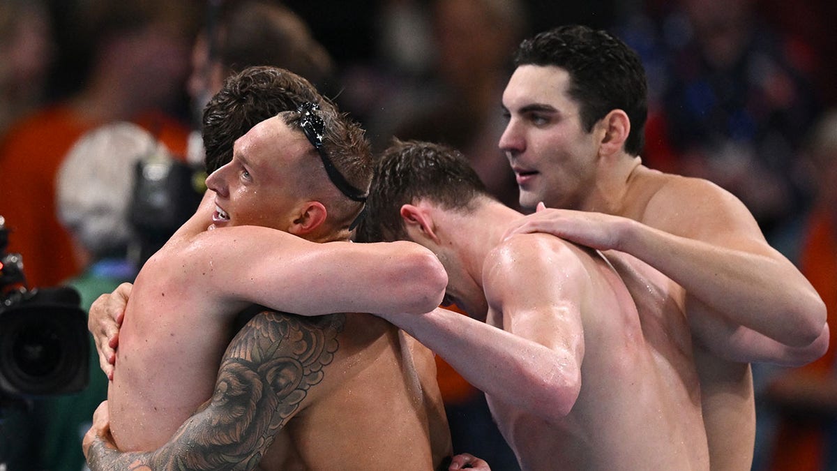 Caeleb Dressel, Hunter Armstrong embrace