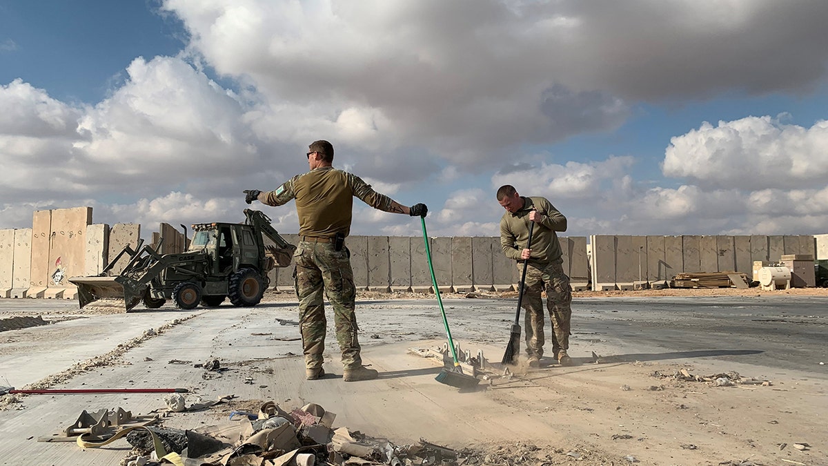 Troops clearing debris at Ain Al-Asad airbase