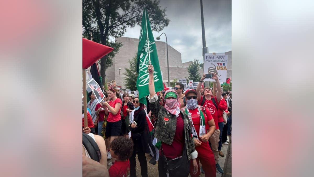 Protester holding Hamas flag