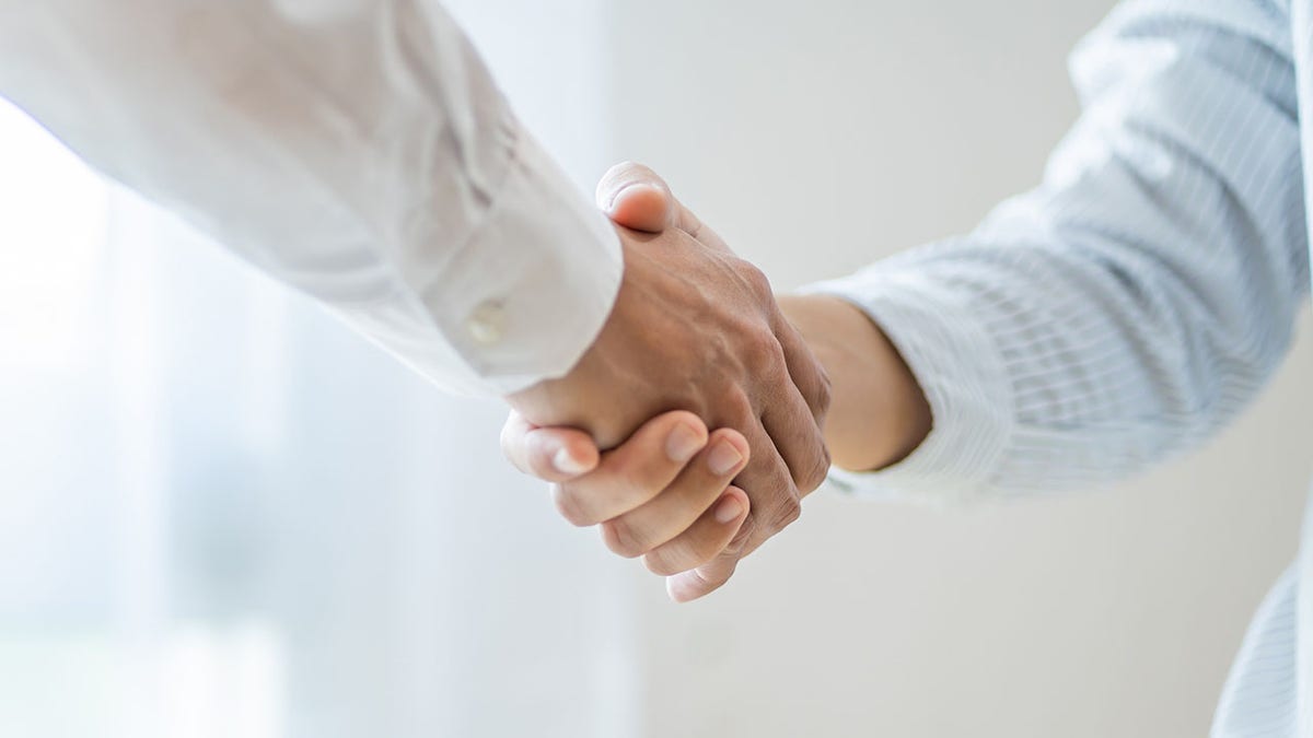 A man and woman shaking hands.