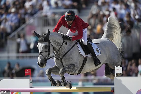 Germany's Christian Kukuk rides Checker 47 during the Jumping Individual final at the 2024 Summer Olympics, Tuesday, Aug. 6, 2024, in Versailles, France. (AP Photo/Mosa'ab Elshamy)