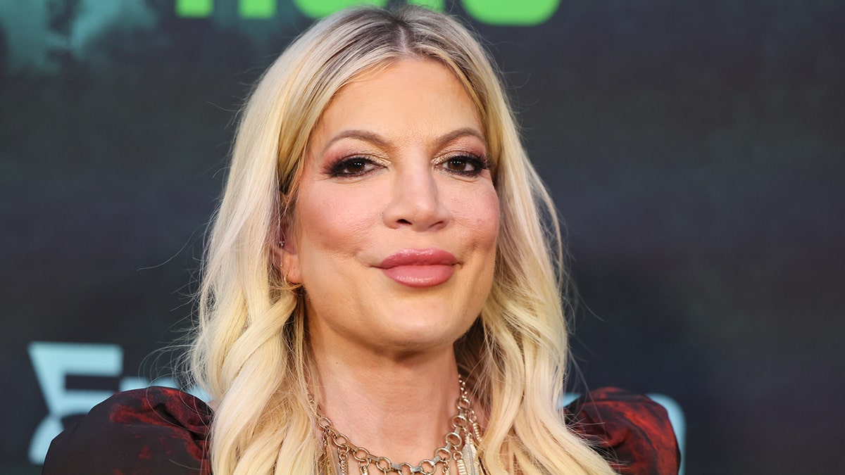 Tori Spelling smiling on the carpet in Los Angeles