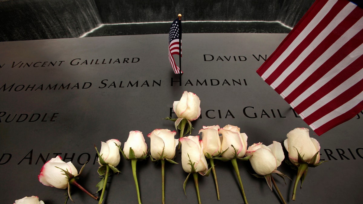 Flowers are placed on the memorial during ceremonies marking the 10th anniversary of the 9/11 attacks on the World Trade Center, in New York