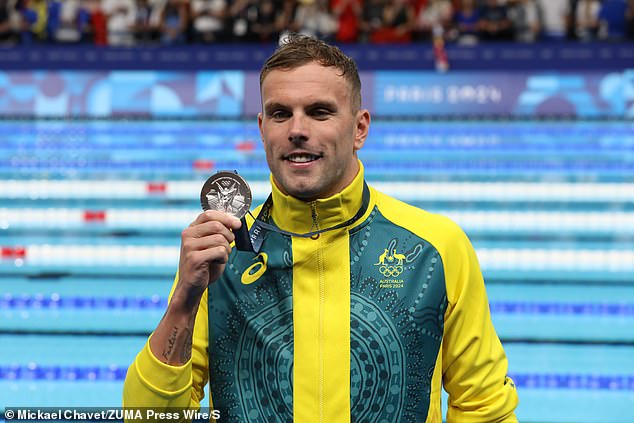 The Chinese star set a stunning world record as he finished a second ahead of Chalmers (pictured with his silver medal) - but the Aussie later said he trusts that there was no doping involved in the incredible swim