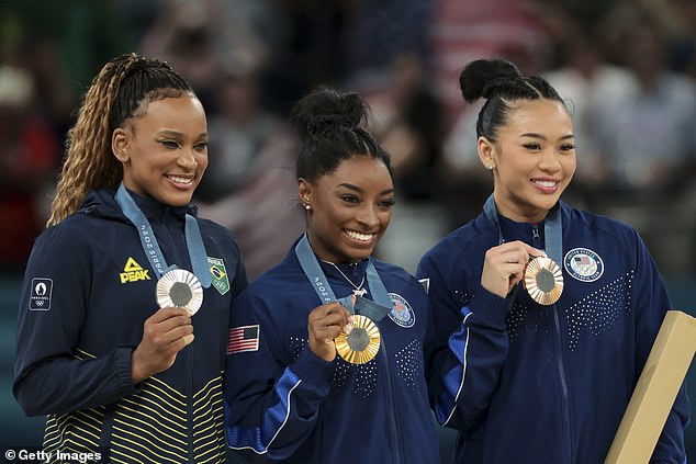 And Biles explained that it was all down to the pressure Rebeca Andrade (left) put on her