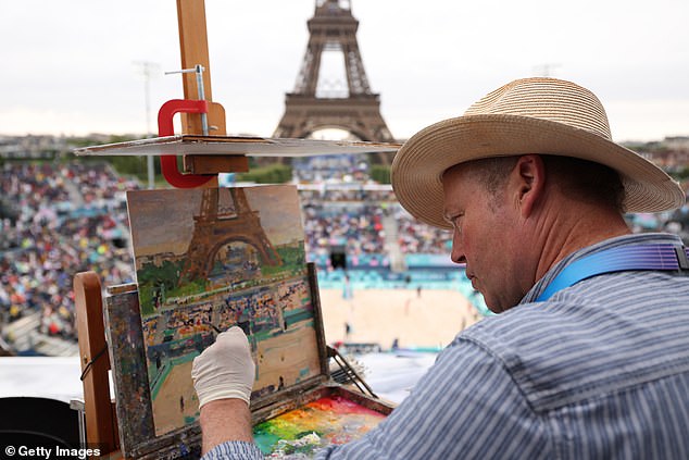 USA has an Olympic gold medal in watercolors from the 1932 Games in LA (Pictured: Artist Peter Spens painting the Eiffel Tower during this summer's Paris Olympics)