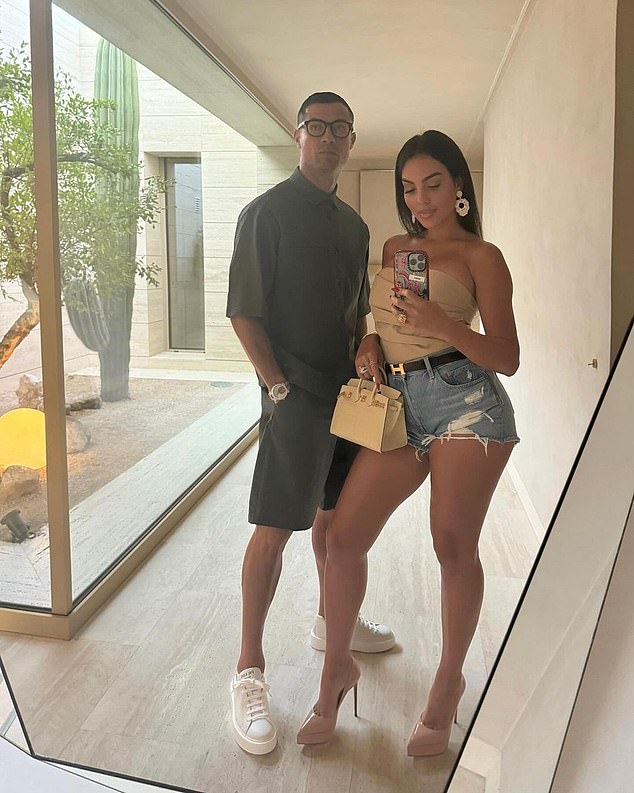 Cristiano Ronaldo wore glasses as he posed for a picture with partner Georgina Rodriguez