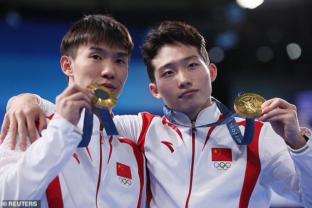 Daoyi Long and Zongyuan Wang of China after winning gold in the Men's Synchronised 3 metre Springboard event