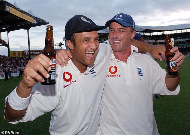 Graham Thorpe holds a beer with Mark Butcher on April 3, 2004