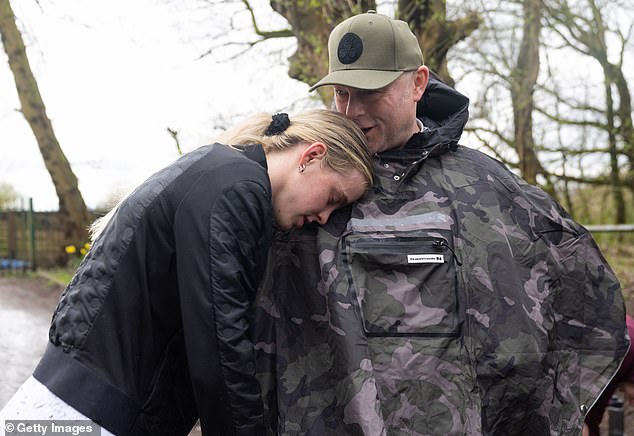 Keely Hodgkinson rests on her father Dean Hodgkinson following a training session on March 17, 2024 in Wigan, England