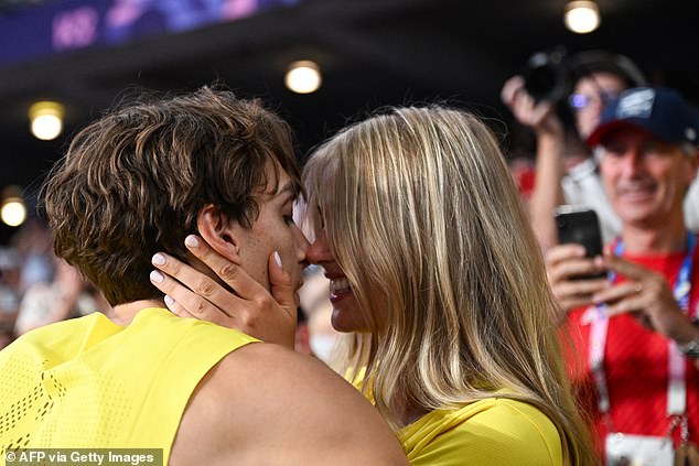 Sweden's Armand Duplantis embraces his girlfriend Desire Inglander after winning gold