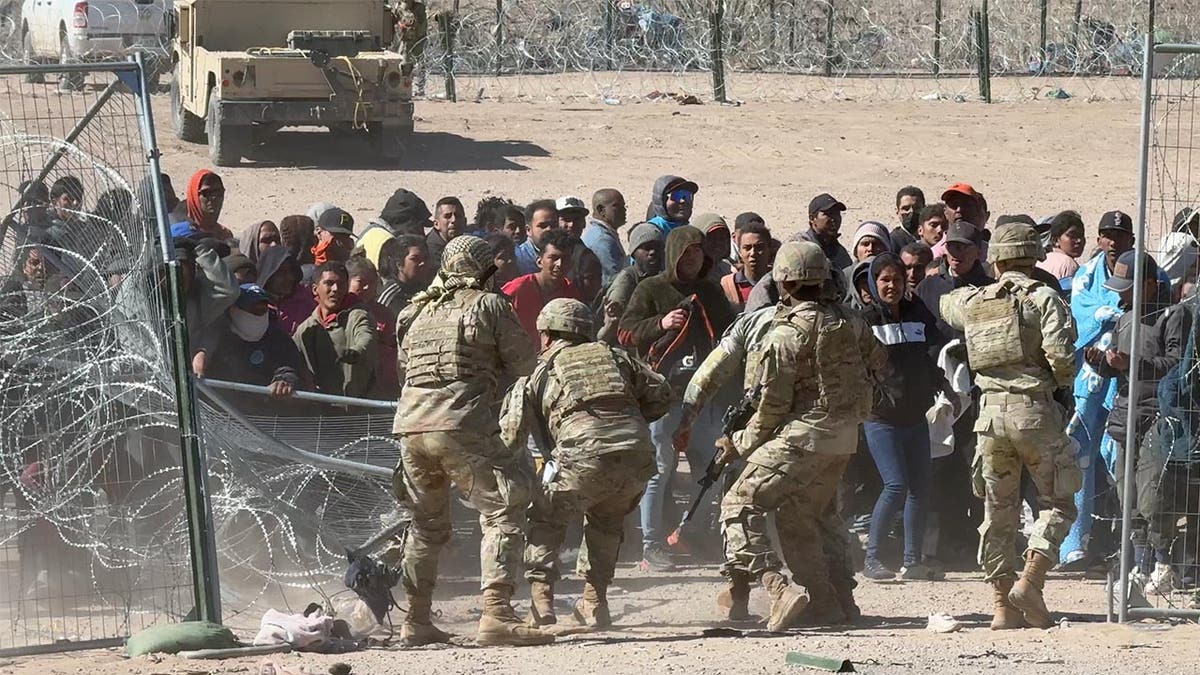 Migrants storming the border gate in El Paso