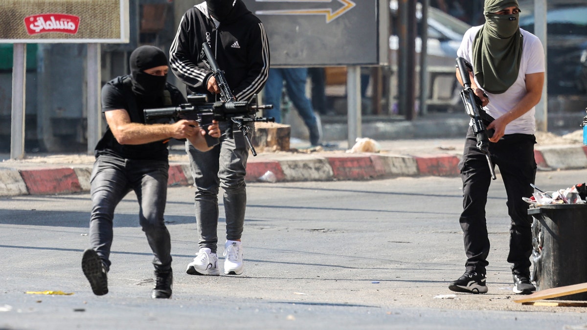 Palestinian militants confronting Israeli forces