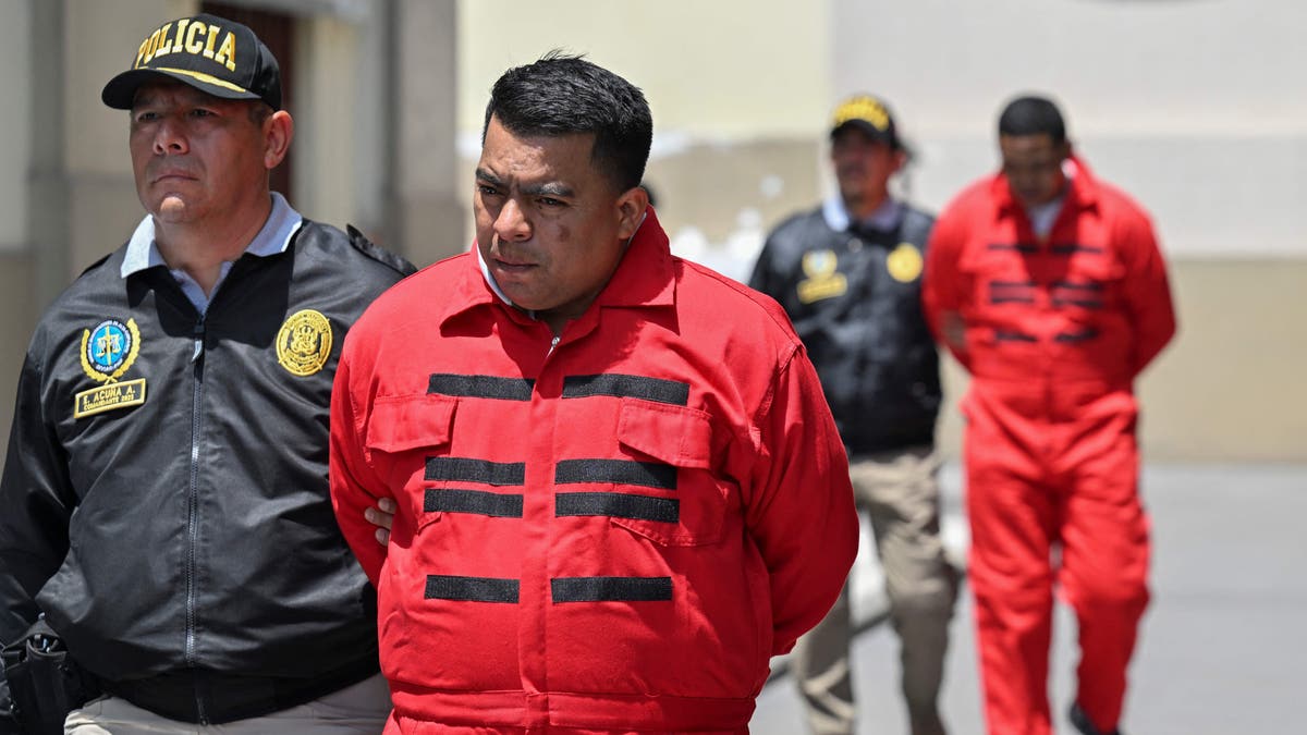 Peruvian police transfer members of the Tren de Aragua criminal organization in Lima on October 5, 2023.