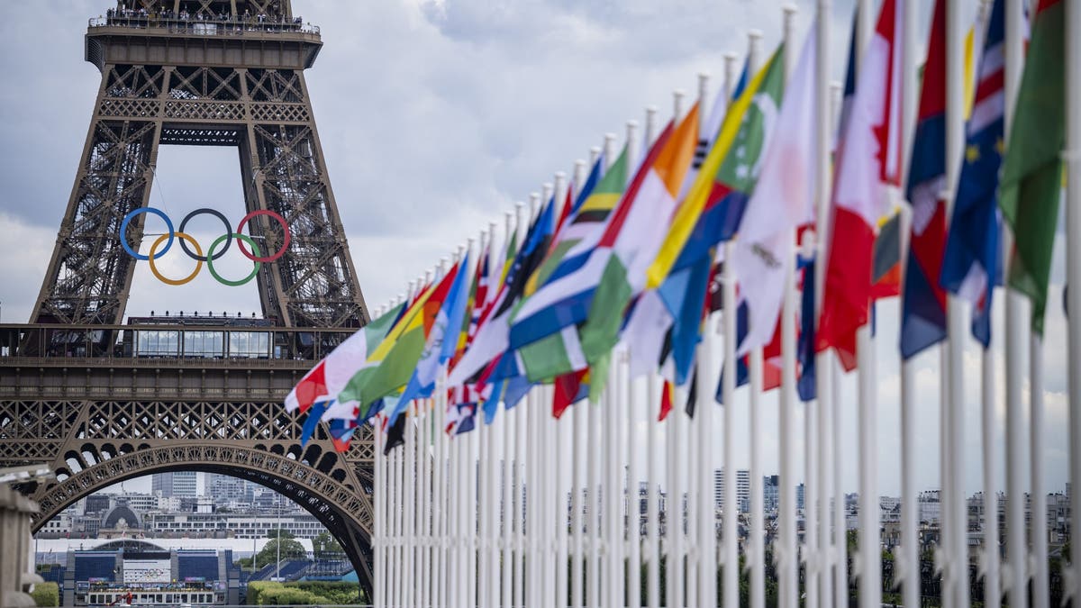 A view of the Eiffel Tower with the Olympic rings and flags of competing nations from the Place du Trocadero ahead of the 2024 Games.