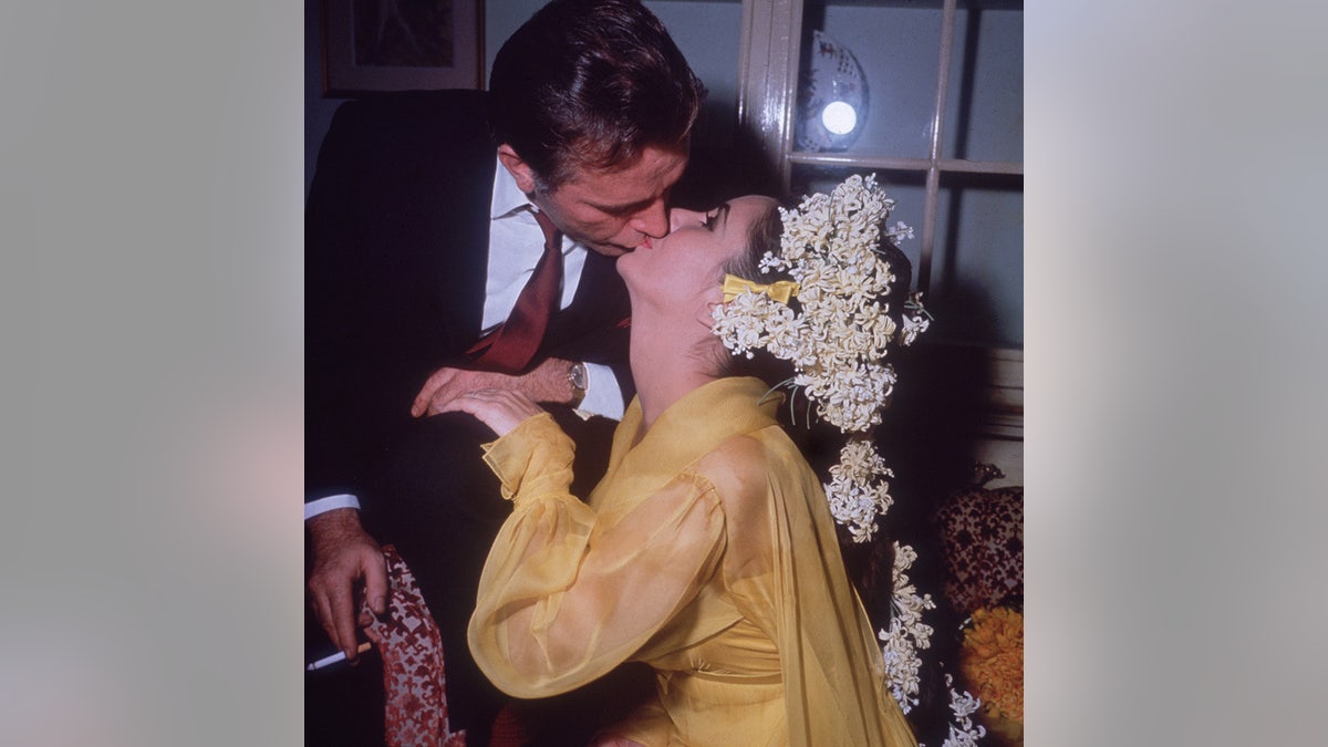 Elizabeth Taylor and Richard Burton sharing a kiss on their wedding day