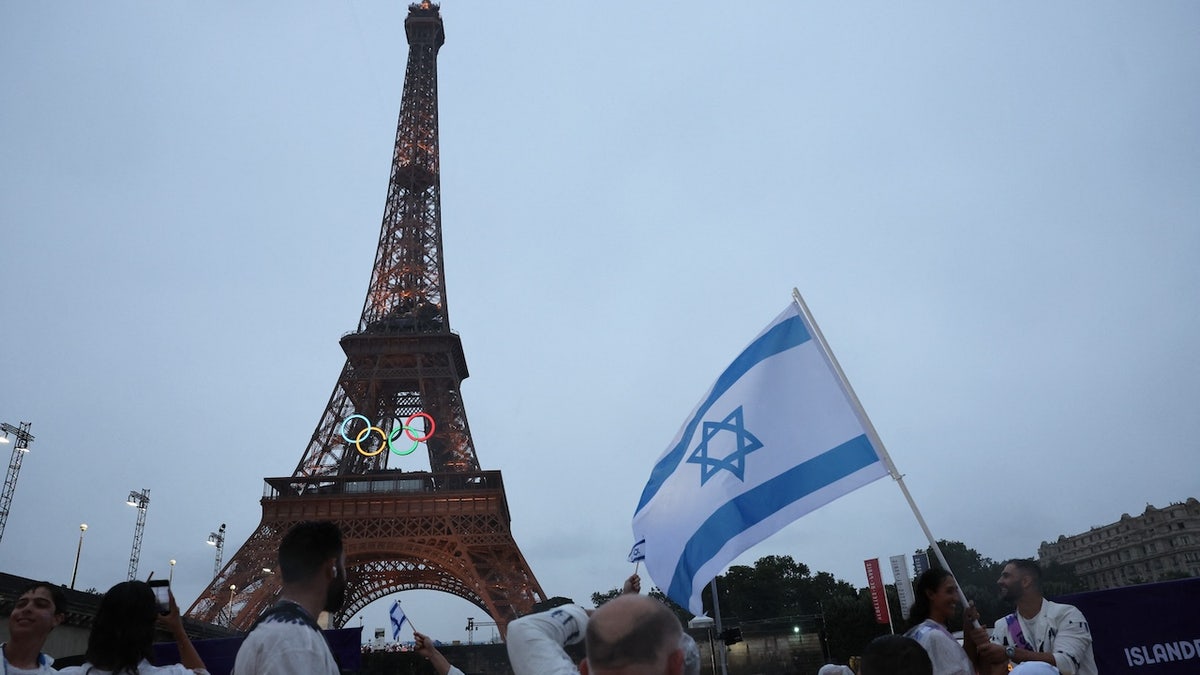 Athletes of Israel observing the Eiffel Tower.