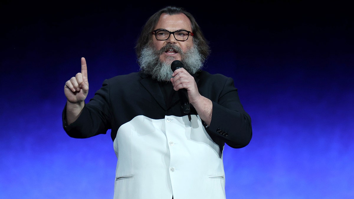 Jack Black holding microphone on stage