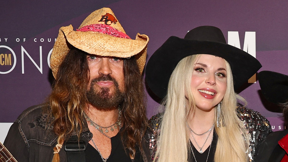 Country star Billy Ray Cyrus in cowboy hat with wife Firerose.