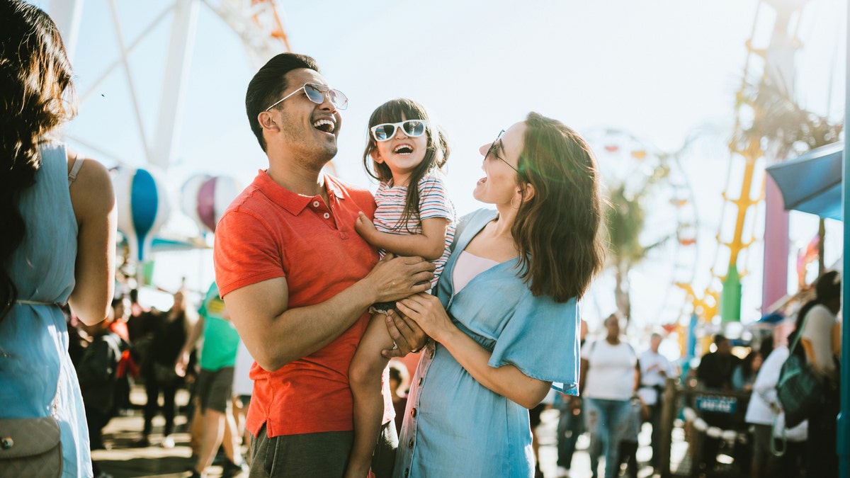 A family at an outdoor fair