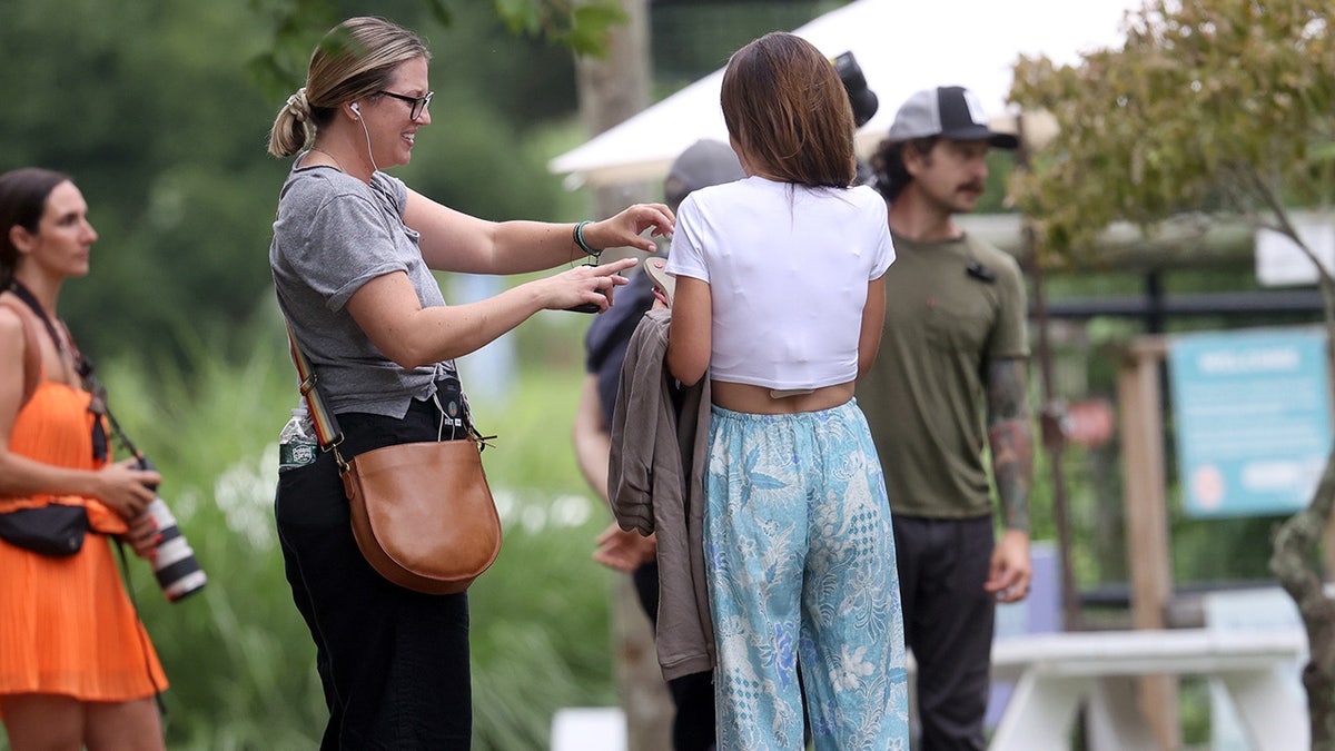 Hilaria Baldwin communicates with a crew member while filming reality show.