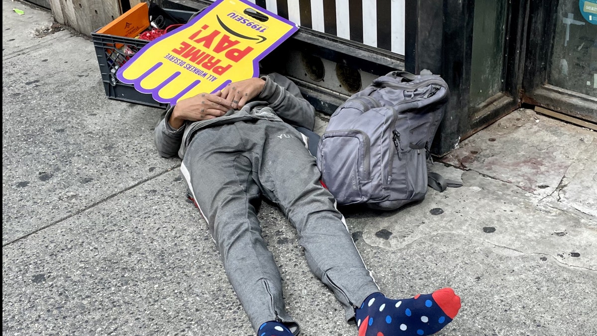 Homeless man with SEIU sign