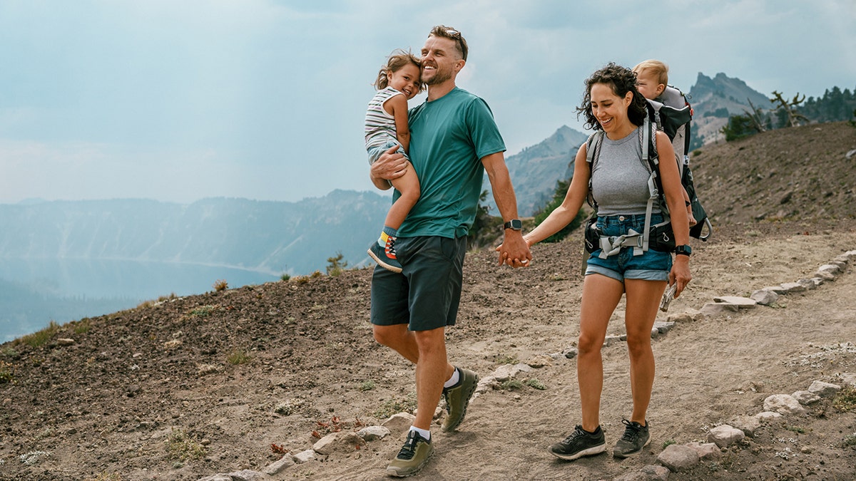 a couple enjoys a hike with their children