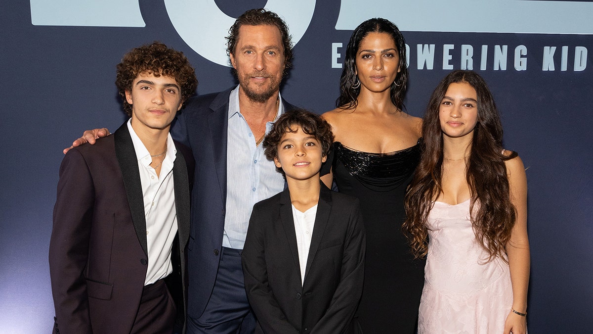 Matthew McConaughey in a blue blazer with his wife Camila in a black dress and their three children, Levi, Livingston, and Vida