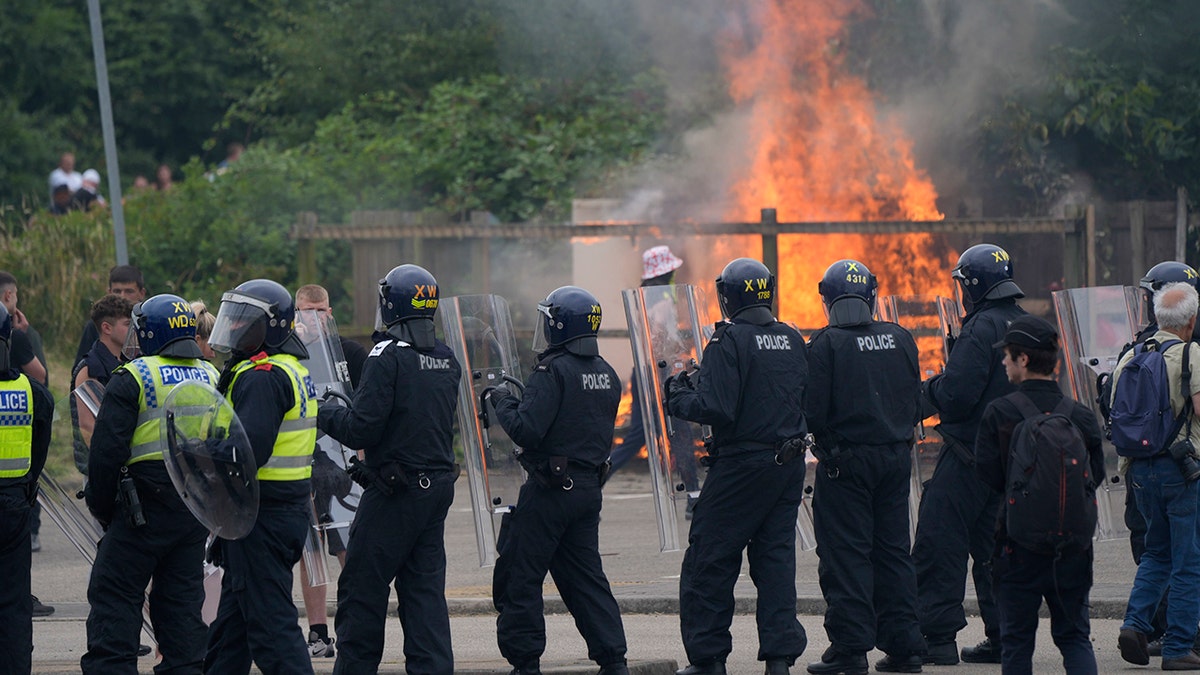 Police officers block protesters